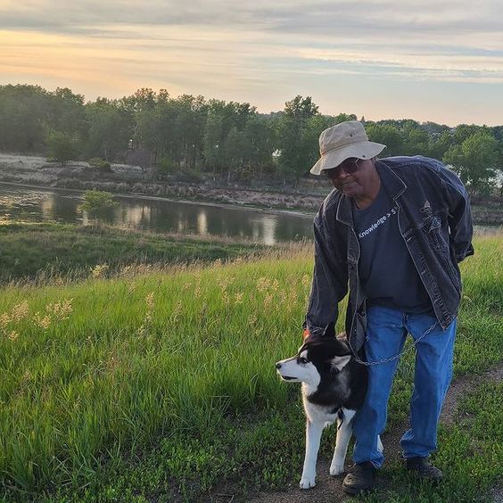 photo of Little Pink Anderson at sunset with his dog blu